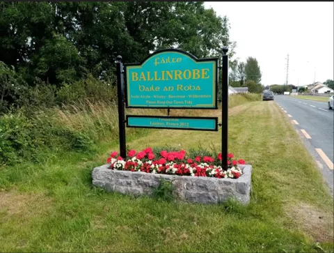 Plean teanga Bhaile an Róba ceadaithe